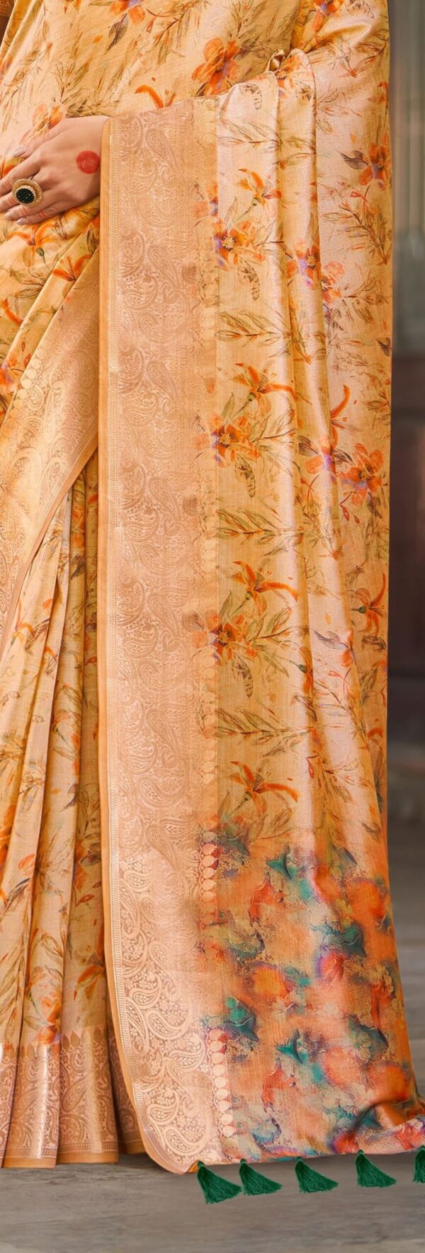 Close-up of zari work and floral print on a soft silk saree